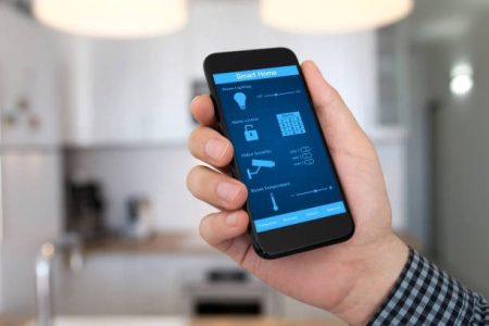 man hand holding phone with smart home on background home room kitchen man hand holding phone with smart home on background home room kitchen